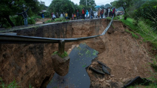 With bare hands, Malawians dig through mud for survivors