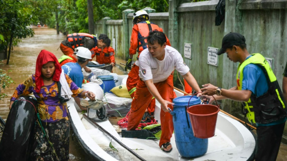 Myanmar residents flee deadly floods in boats and on makeshift rafts