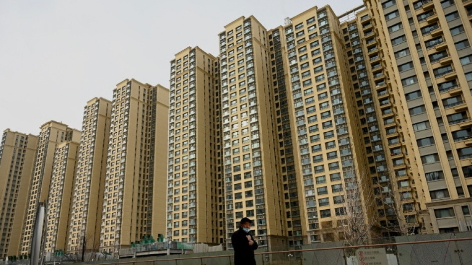 China cuts lending rates, boosting property firms